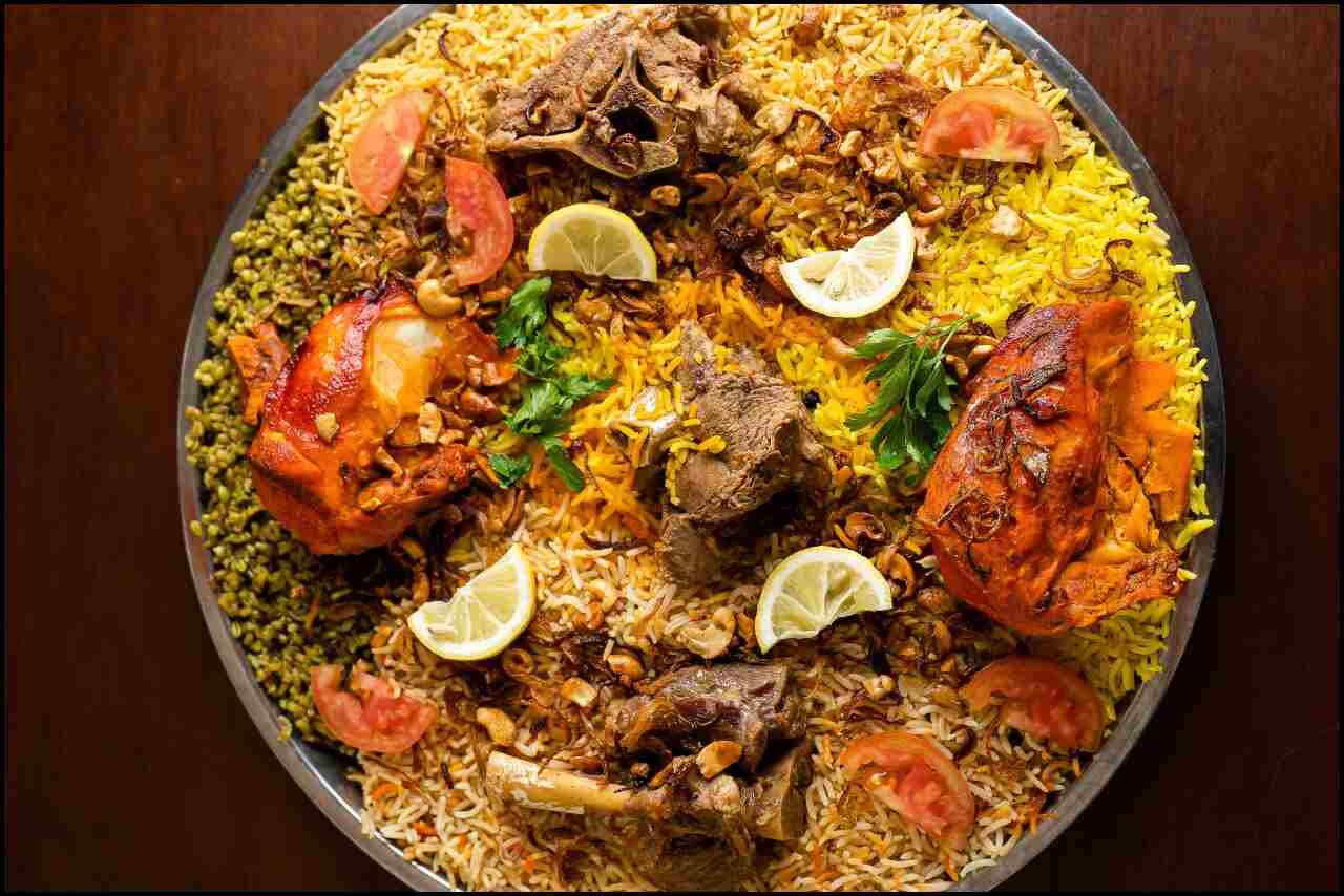 A close-up photo of a plate of mutton biryani, a fragrant South Asian rice dish